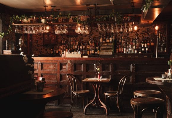 Cozy rustic bar with warm lighting, ideal for networking events and gatherings.