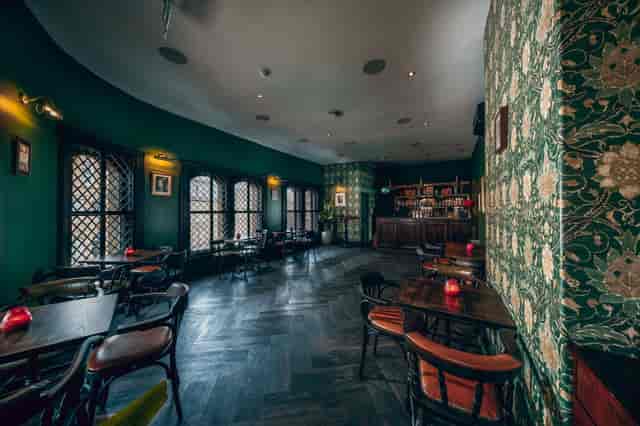 Stylish Maven Bar with green floral walls, perfect for cocktail receptions and meetings.