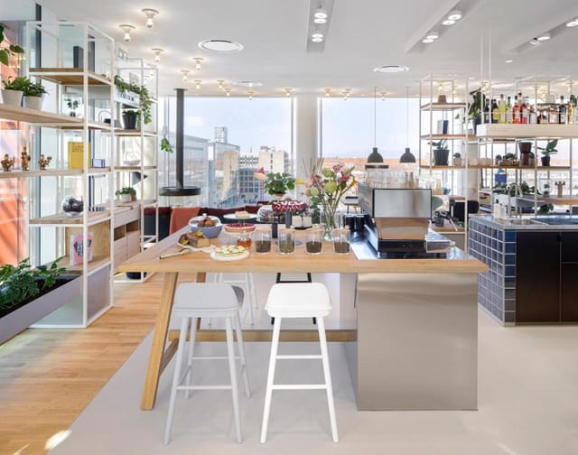 Modern event space in Zoku Copenhagen with stylish kitchen, ideal for networking and workshops.