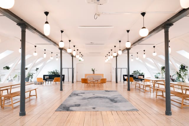 Spacious event space with high ceilings, ideal for workshops and networking events.