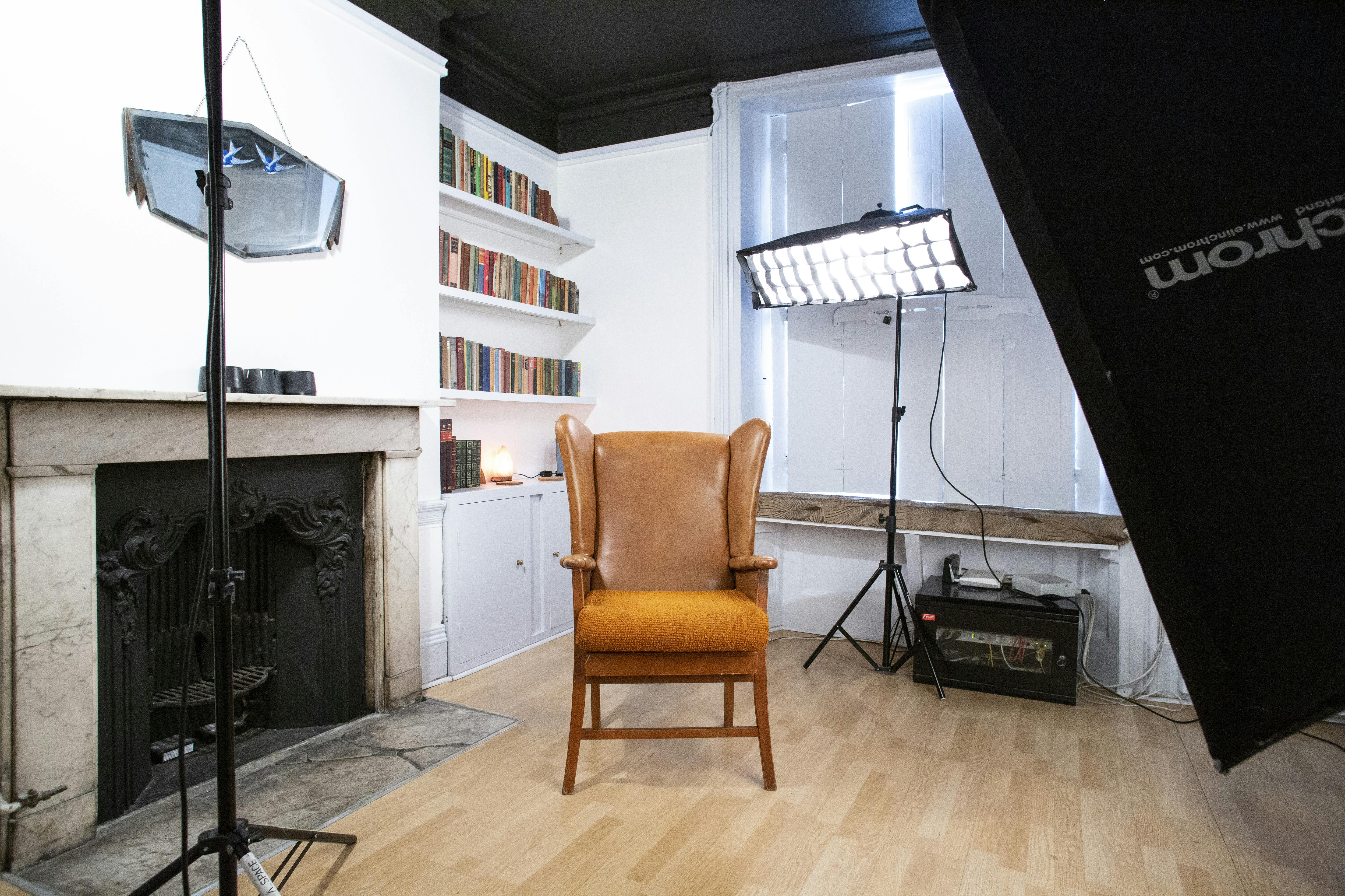 Minimalist interview setup with central chair, ideal for panel discussions and video production.