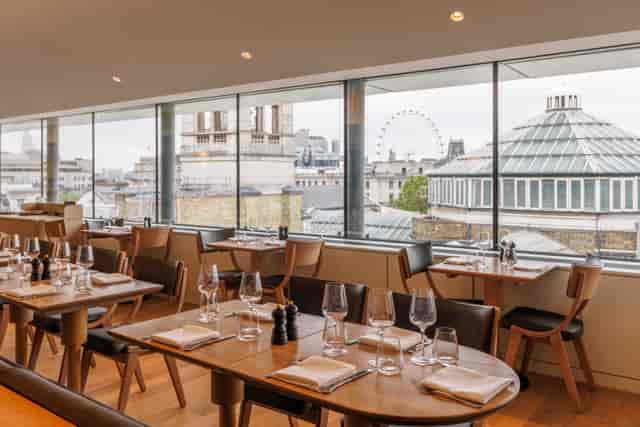 Elegant dining space with skyline view at The Portrait Restaurant, ideal for corporate events.