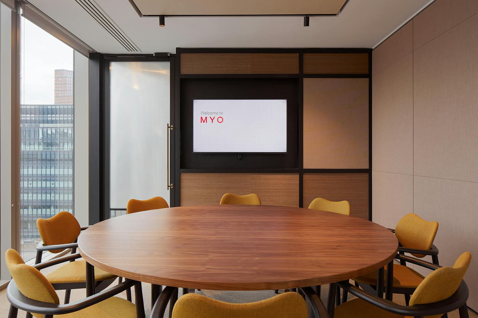 Modern meeting room at The Hub, Liverpool Street with round table and natural light.