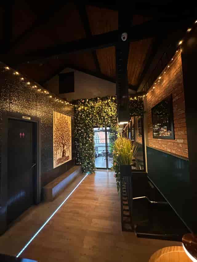Stylish Ora Lounge entrance with greenery, perfect for networking events and gatherings.