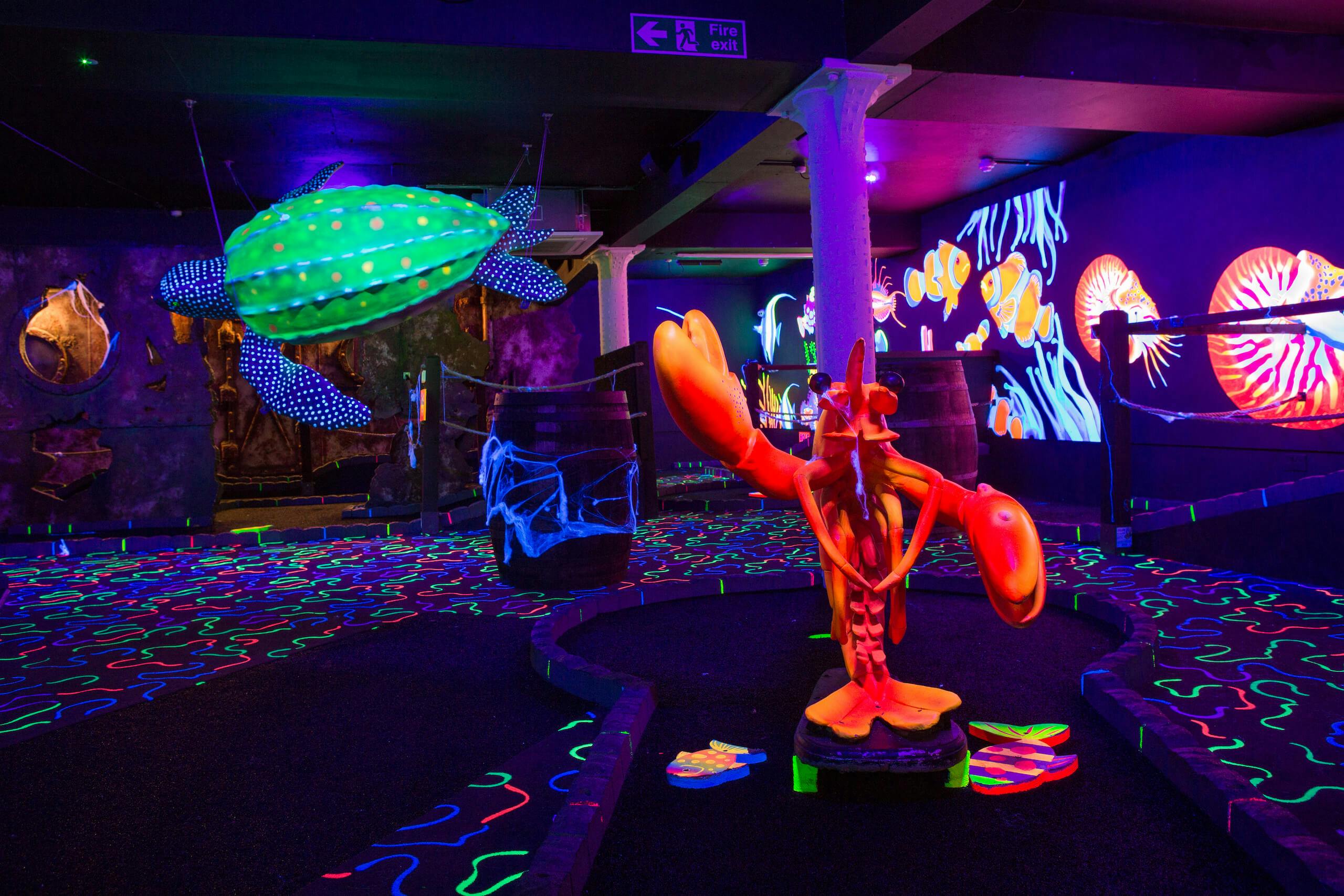 Vibrant Indian Ocean-themed event space with neon decor in Jungle Rumble Glasgow.