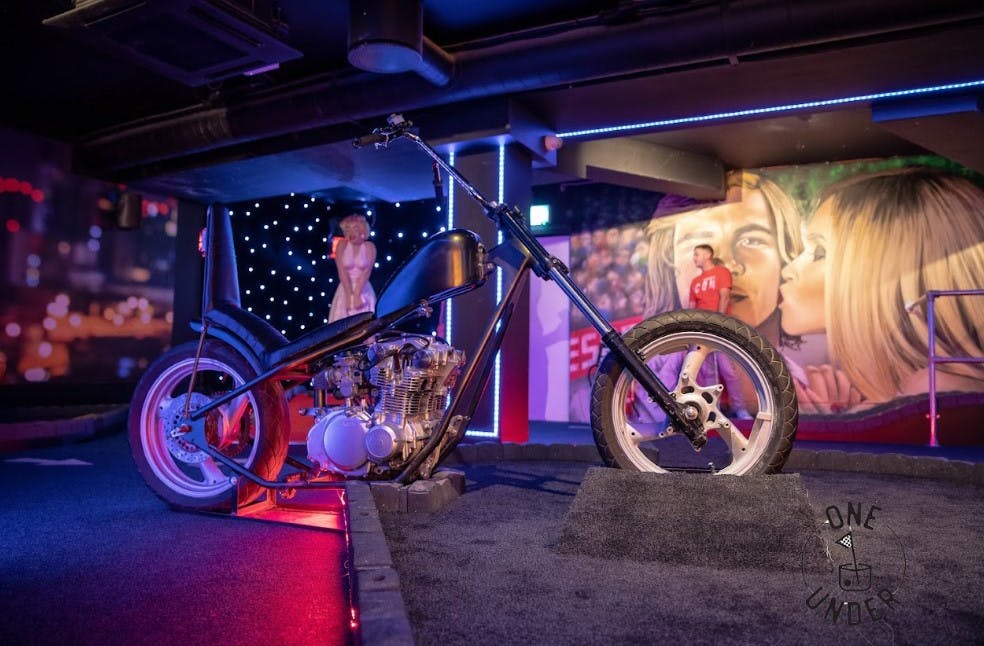 GlasVegas event space with striking motorcycle, vibrant murals for creative gatherings.