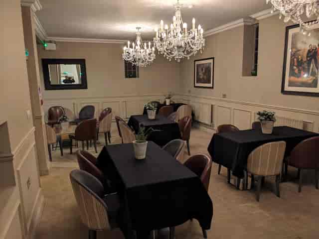 Elegant meeting space with chandeliers for intimate corporate events and workshops.