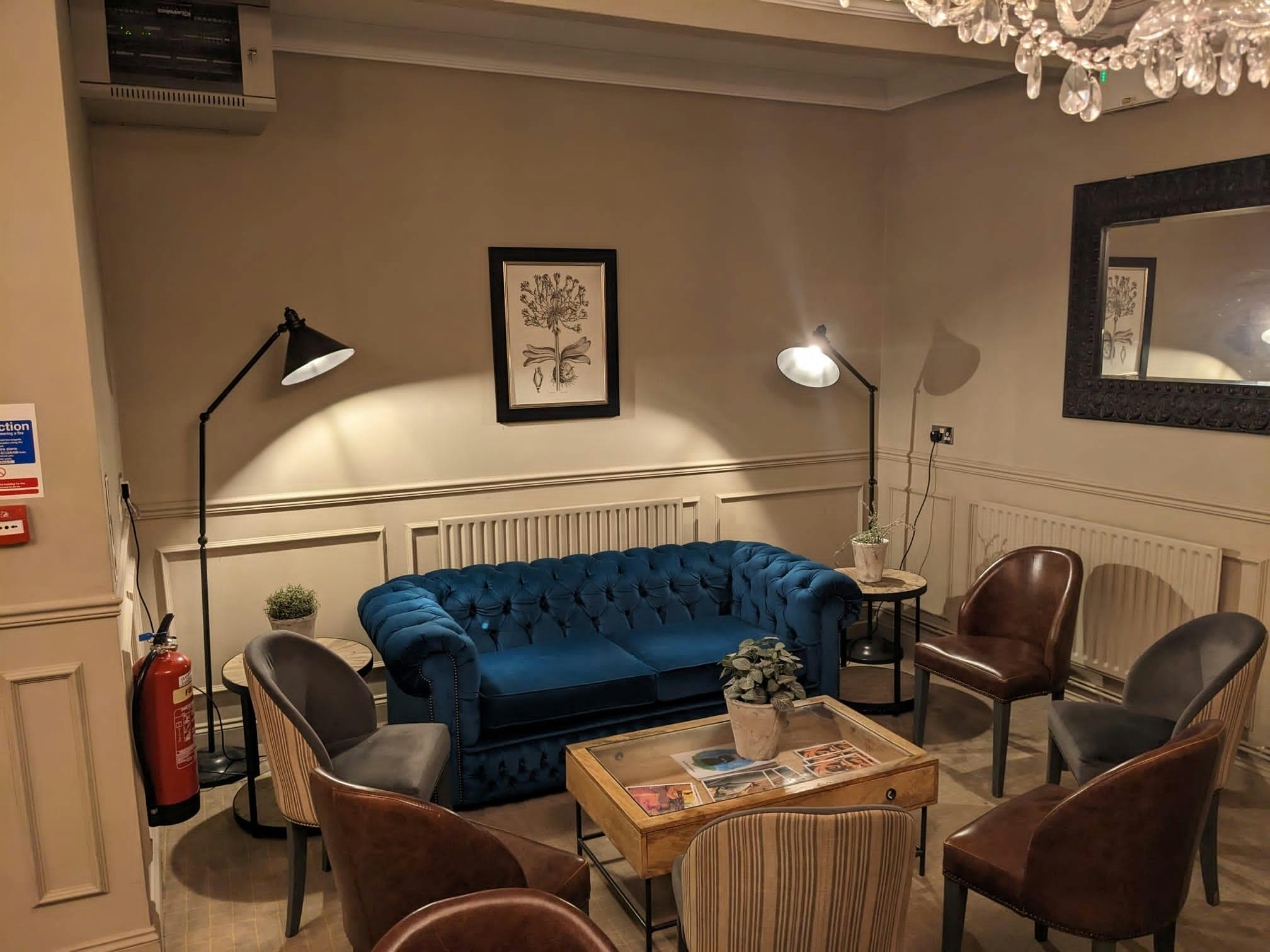 Cozy meeting space with plush blue sofa for networking and breakout sessions.