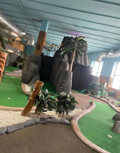 Mayan-themed indoor mini-golf venue for corporate events and team-building activities.