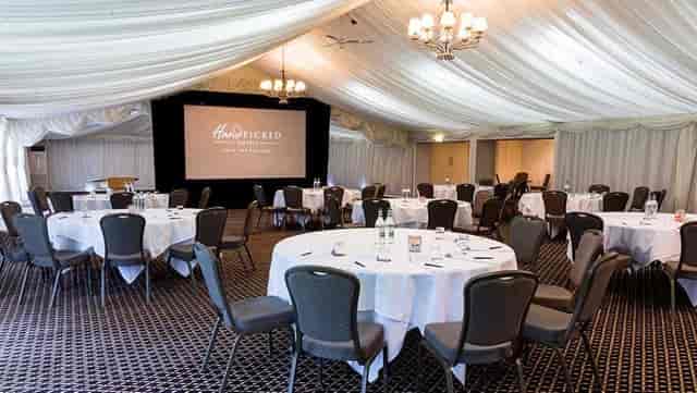 Audleys Wood Garden Pavilion corporate marquee with cabaret seating for business presentations.