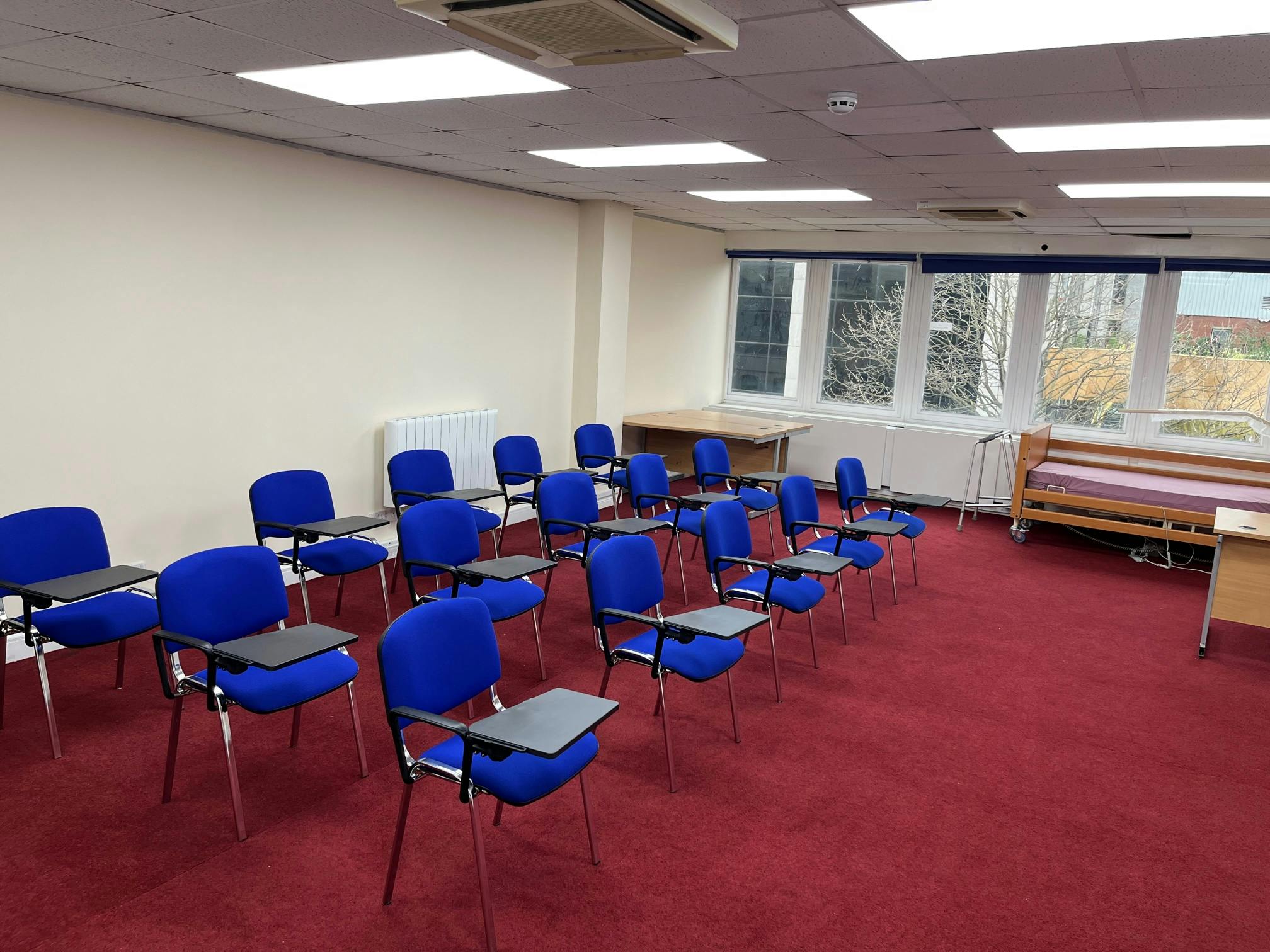 Training room in Whitechapel with blue chairs, ideal for workshops and meetings.