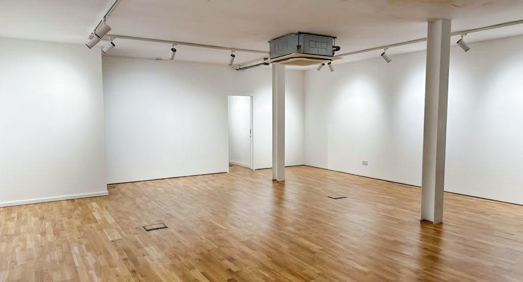 Versatile blank canvas event space with natural light for meetings and workshops.