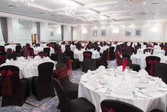 Elegant Wessex Suite banquet hall with white linens, ideal for weddings and corporate events.