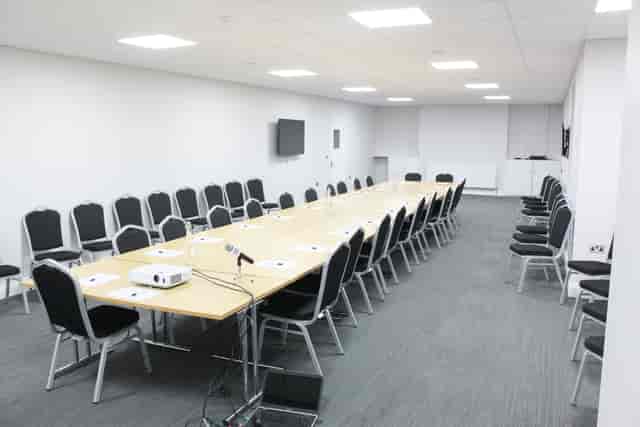 Conference Room in AMI Spaces with long table, ideal for professional meetings and events.