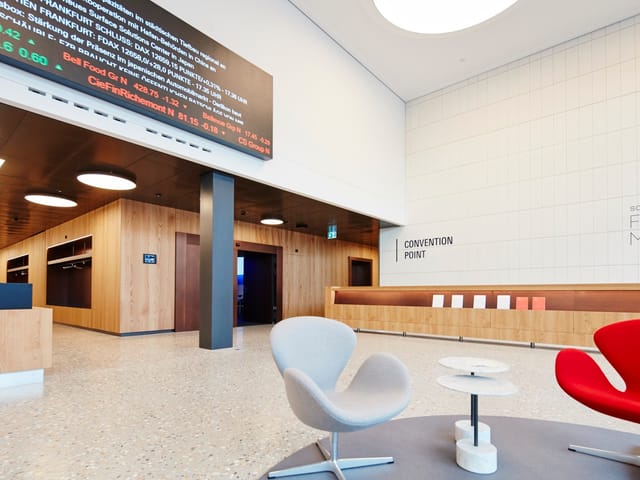 Modern convention center lobby with seating, ideal for conferences and networking events.
