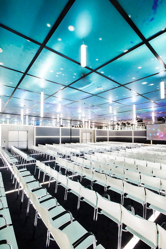 Modern event space at Supernova Jaarbeurs with white chairs, ideal for conferences.