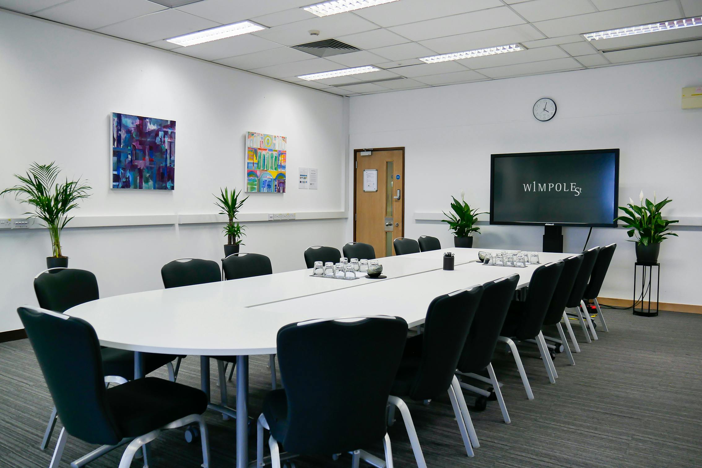 Dame Deirdre Hine Room: modern meeting space with oval table for professional events.