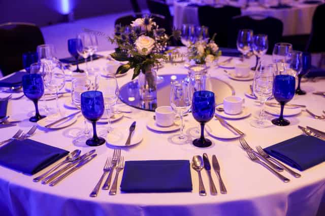 Elegant banquet table with blue glassware in RCP London Events for corporate gatherings.