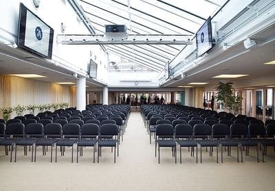 Loki conference space with black chairs and natural light for seminars and presentations.