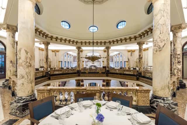 Elegant event space with grand columns at Royal Tropical Institute for upscale gatherings.