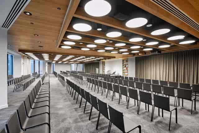 Modern event space with sleek black chairs, ideal for conferences and workshops.