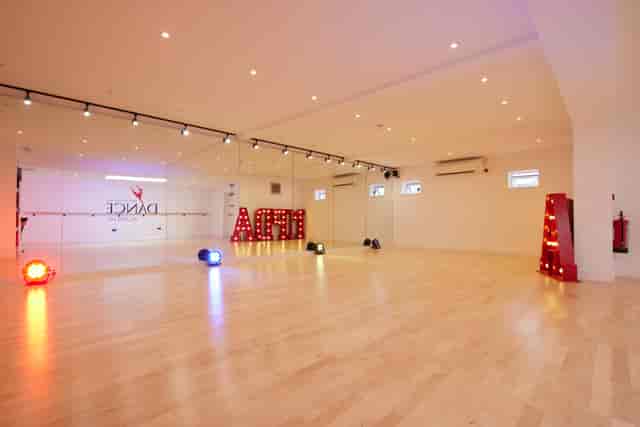 Versatile dance studio with polished floors, ideal for workshops and events.