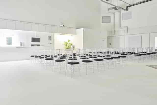 Minimalist event space with clear chairs for meetings at S2 Royal Arsenal, London.