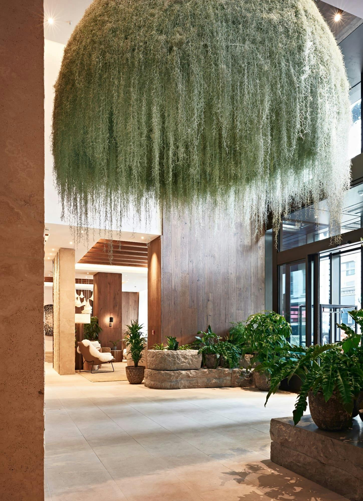 Clover lobby at 1 Hotel Mayfair with lush greenery, perfect for networking events.