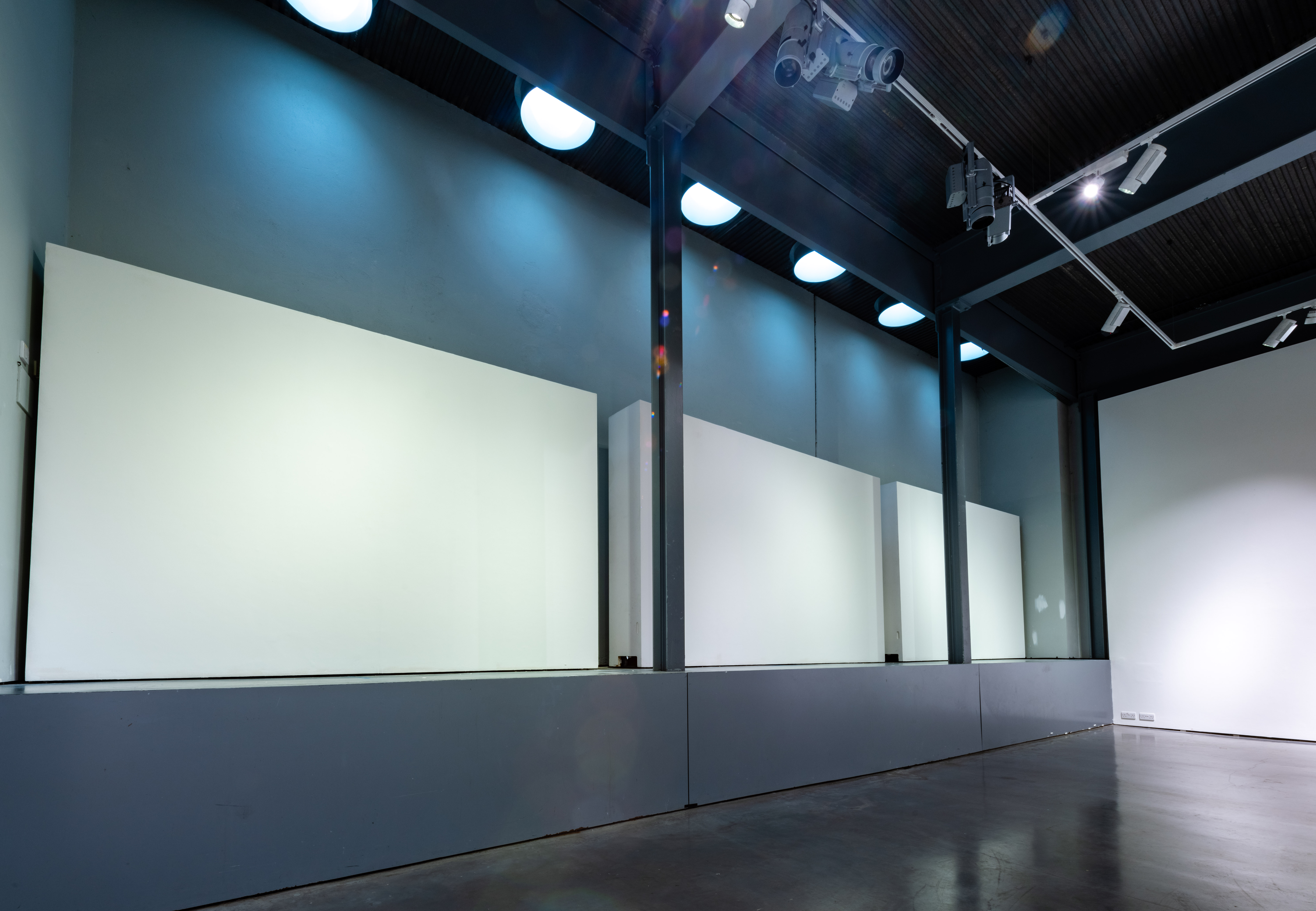 Versatile East Gallery event space with large blank walls for customizable presentations.