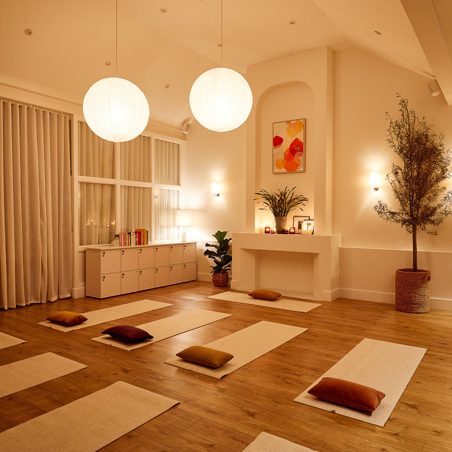 Serene yoga studio with soft lighting, ideal for wellness retreats and mindfulness workshops. - Banner