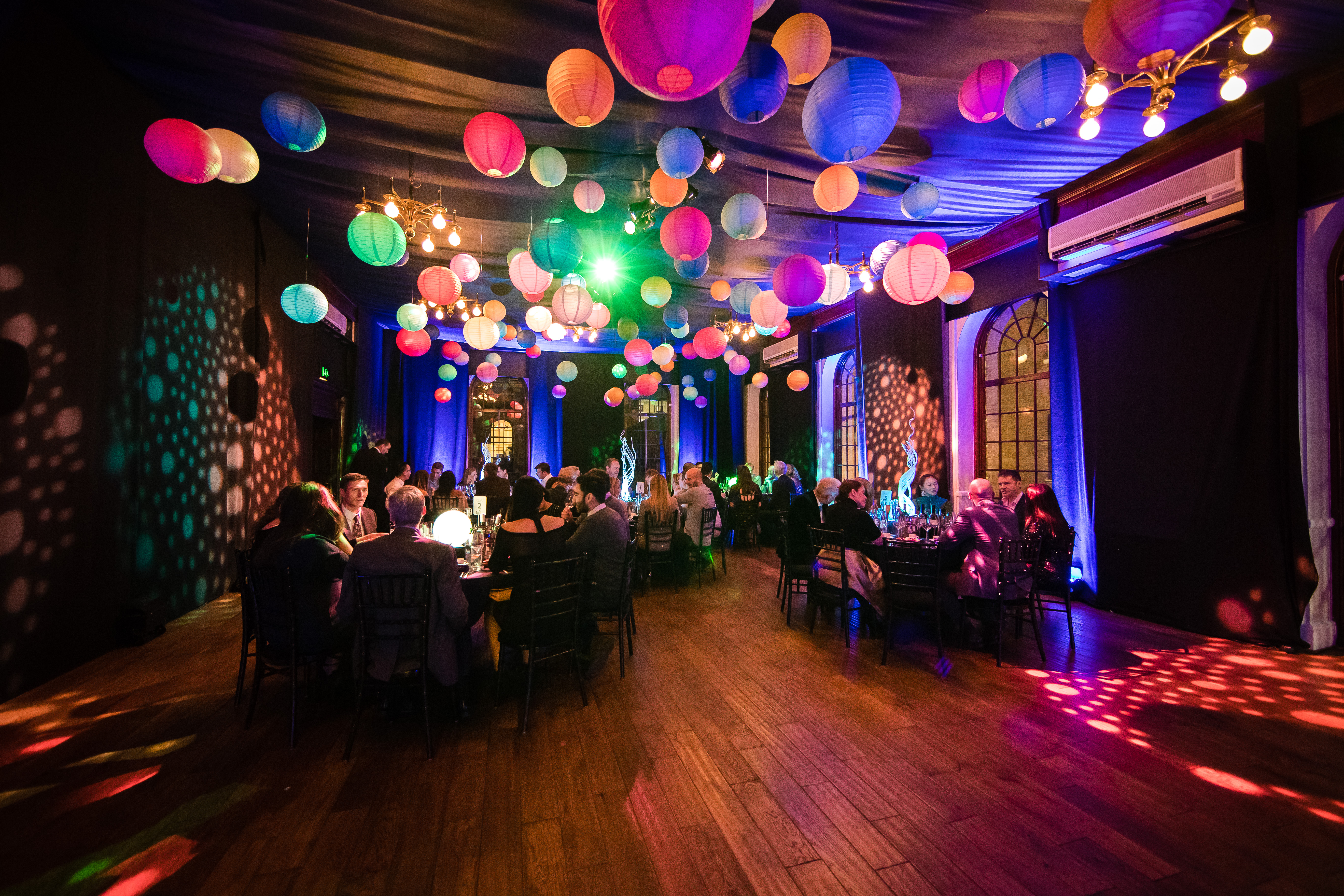 Christmas party venue with colorful lanterns and elegant decor at The Brewery. - Banner