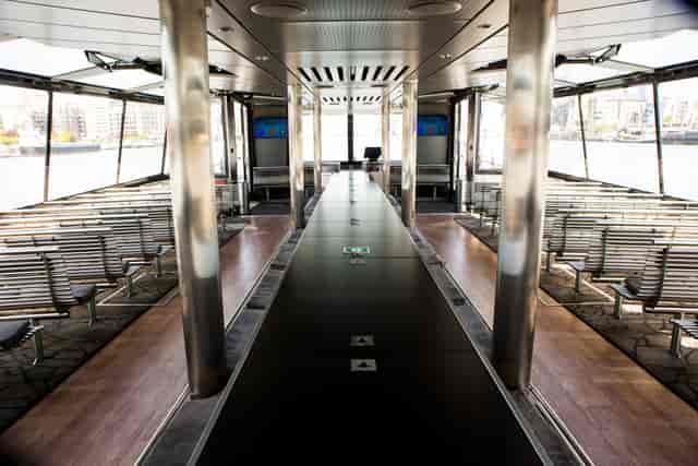 Sleek event space on City Cruises vessel with scenic views for networking and presentations.