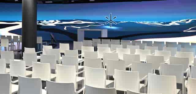 LED stage in modern event space with digital backdrop for conferences and workshops.