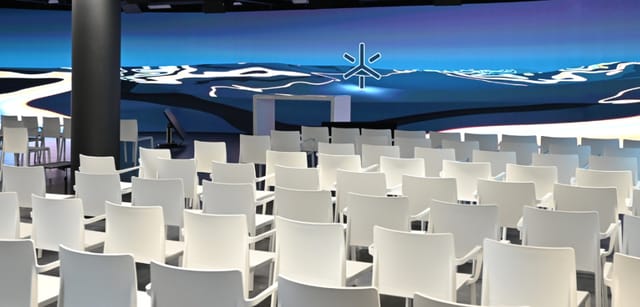 LED stage in modern event space with digital backdrop for conferences and workshops.