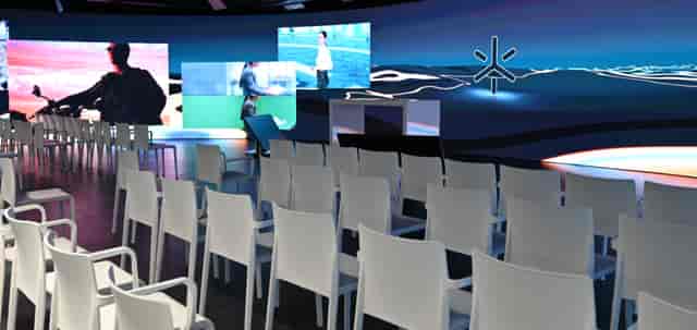 LED stage with large screens in modern event space for corporate meetings and presentations.