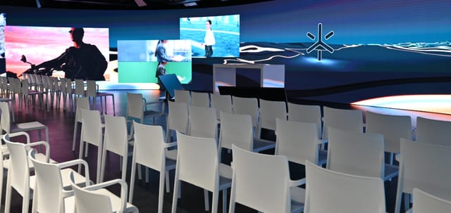 LED stage with large screens in modern event space for corporate meetings and presentations.
