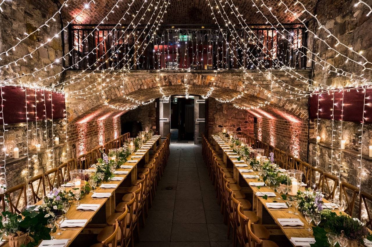 Elegant banquet table in rustic event space for weddings and corporate gatherings.