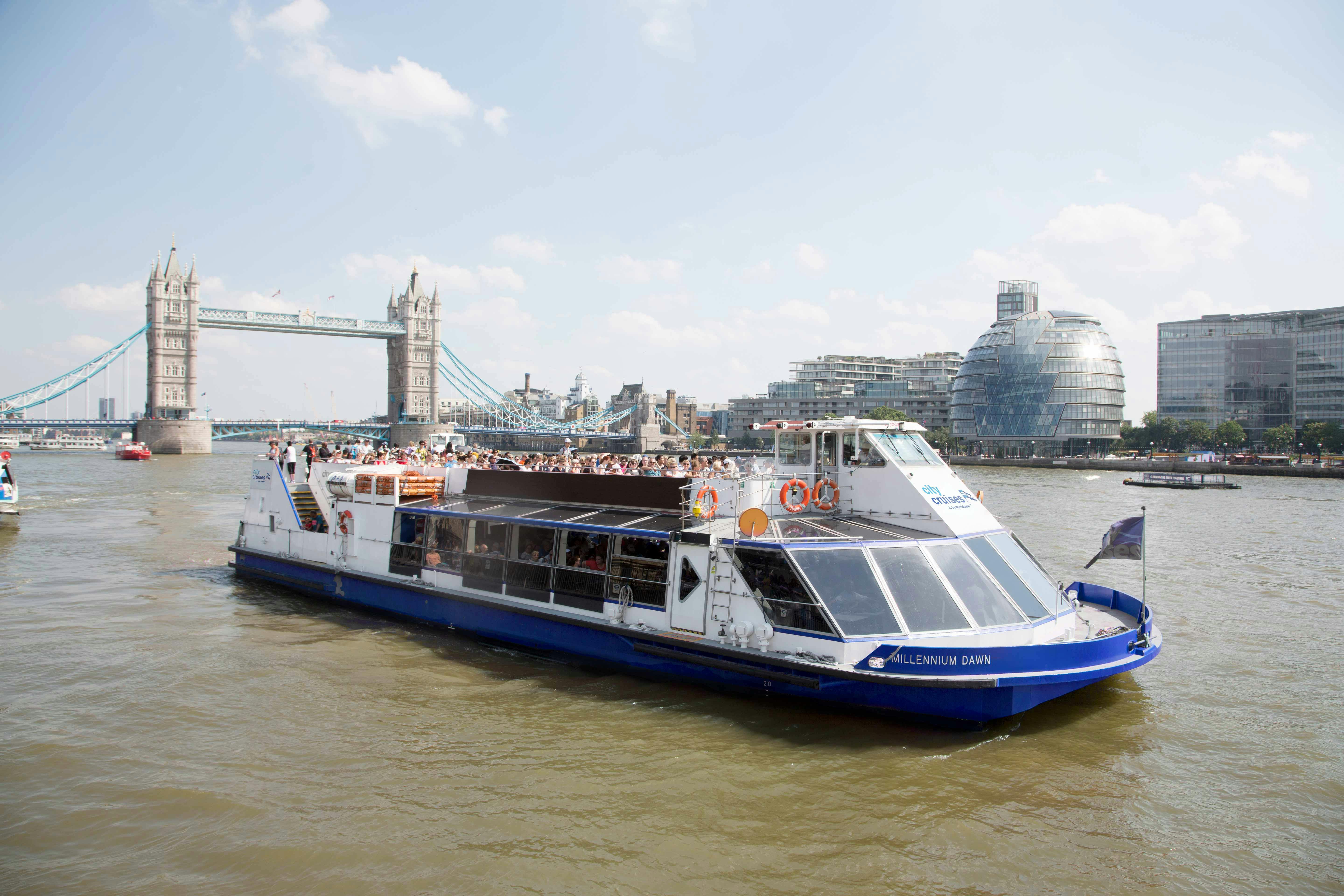 "Spacious event boat on Thames with Tower Bridge, ideal for corporate and social gatherings."