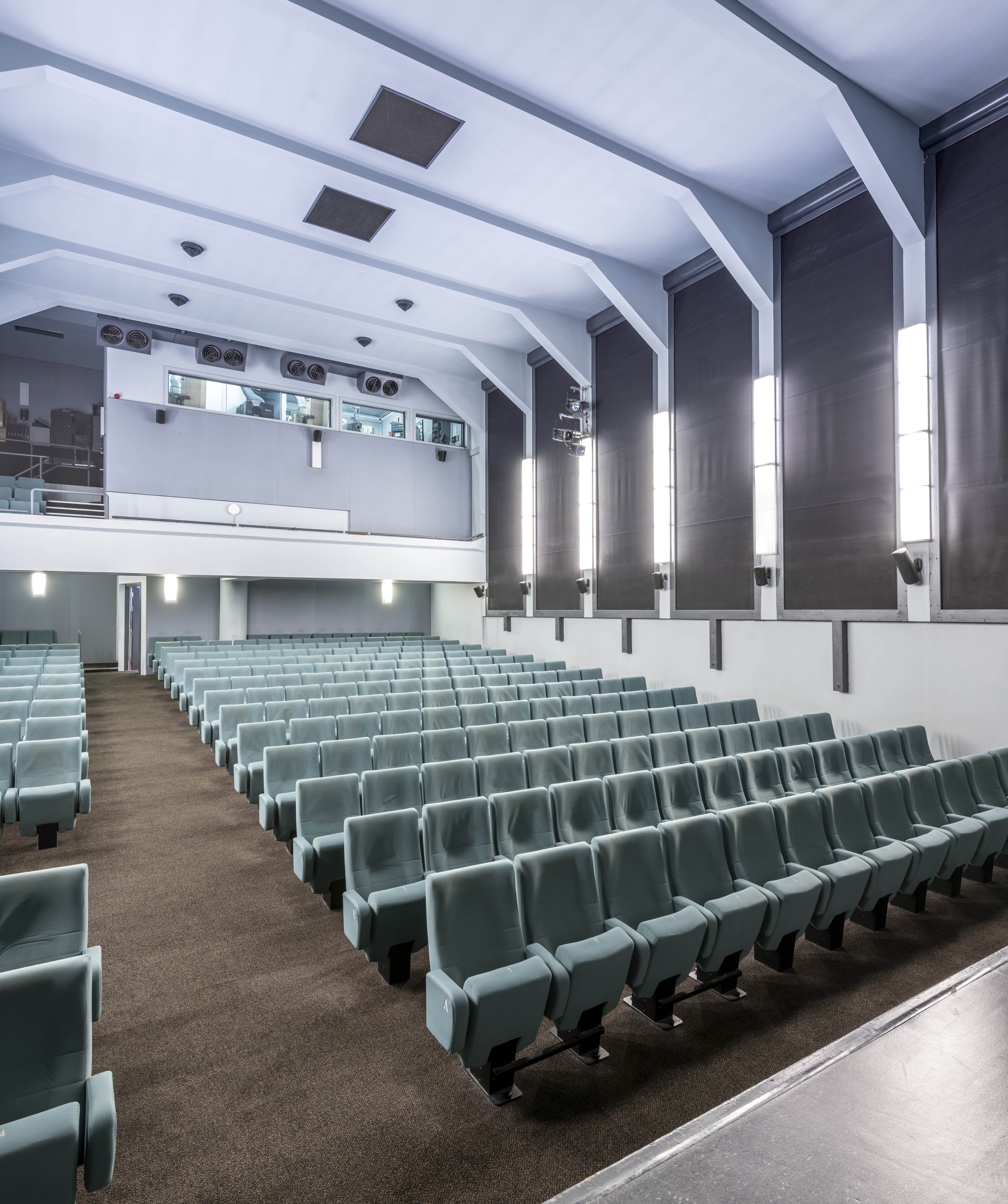 Ciné Lumière auditorium with tiered seating for conferences and presentations. - Banner