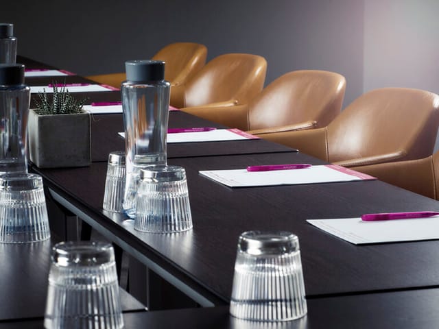 County Suite meeting setup with long table, notepads, and modern chairs for professional events.