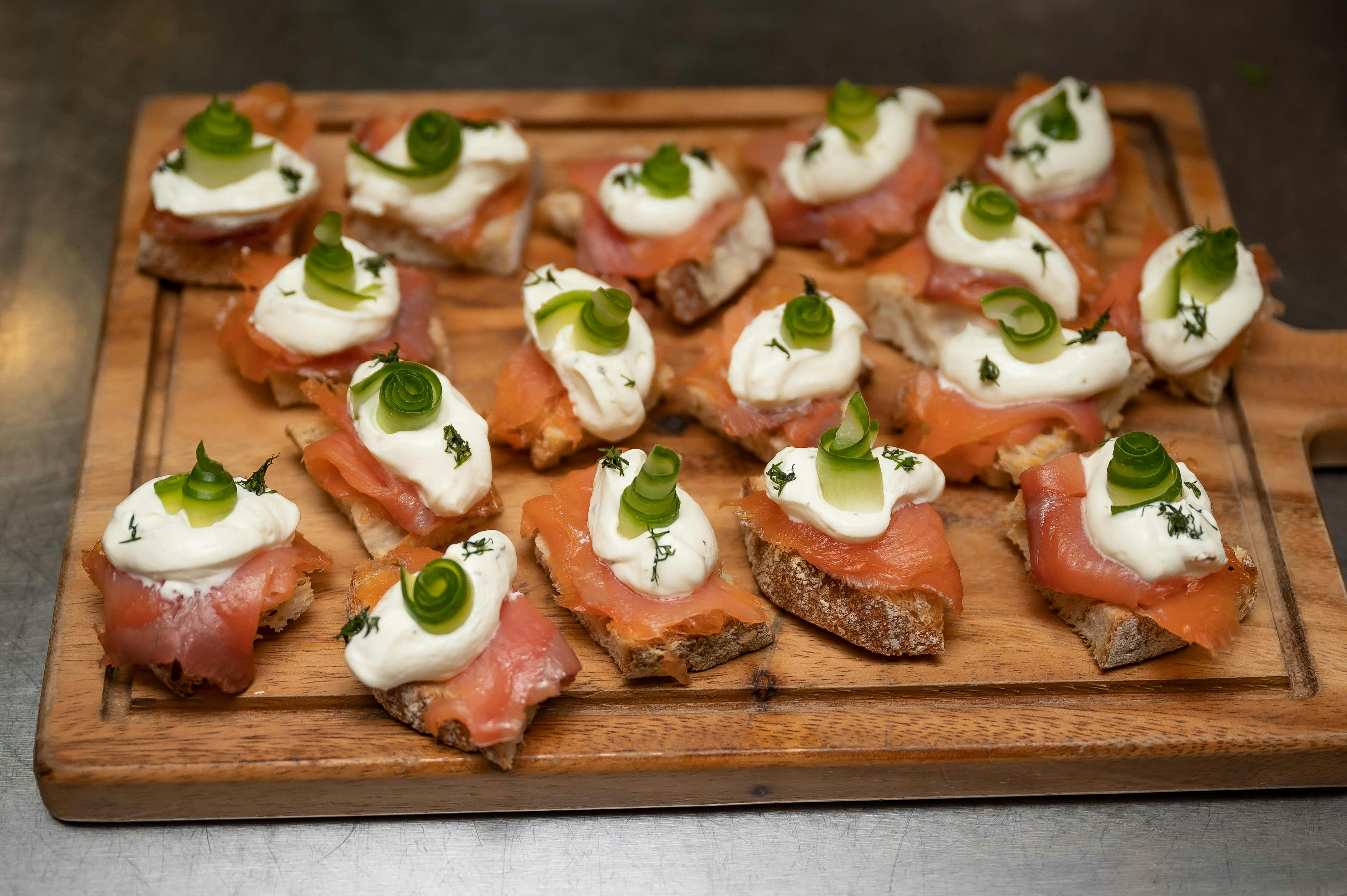 Elegant smoked salmon canapés on artisanal bread for cocktail receptions.