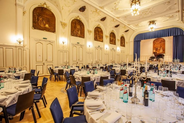 Elegant banquet hall with round tables, ideal for corporate events and celebrations.