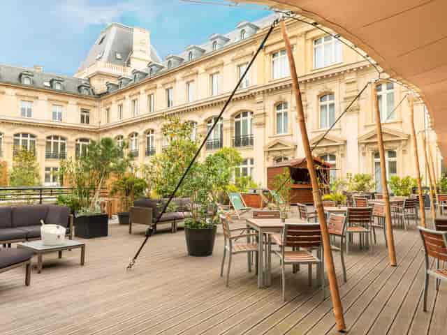 Stylish outdoor terrace at Crowne Plaza Paris for events, featuring modern furniture and greenery.