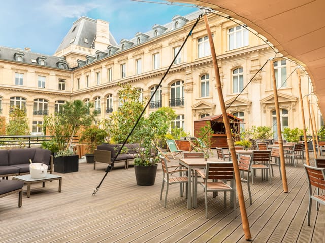Stylish outdoor terrace at Crowne Plaza Paris for events, featuring modern furniture and greenery.