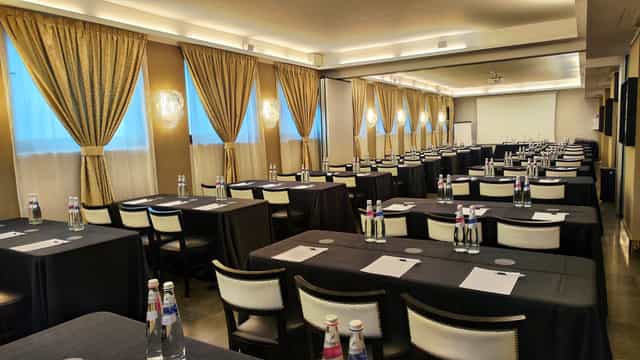 Fornasetti meeting room setup with elegant decor for corporate events and workshops.