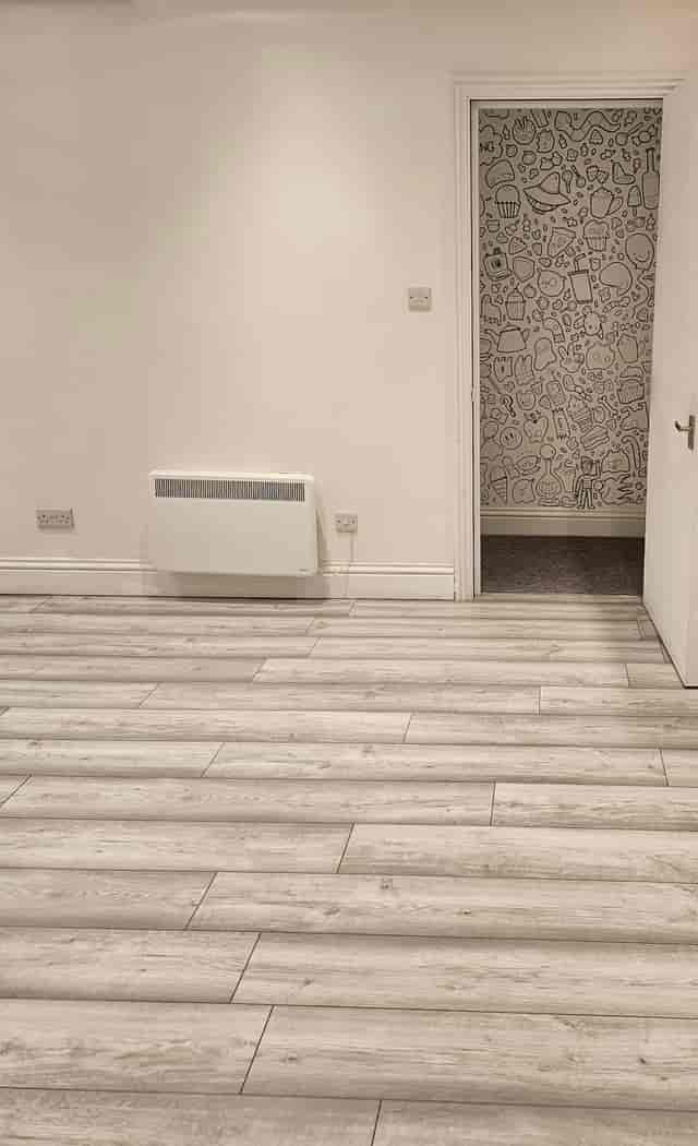 Minimalist lounge with light wood flooring, perfect for intimate events and workshops.