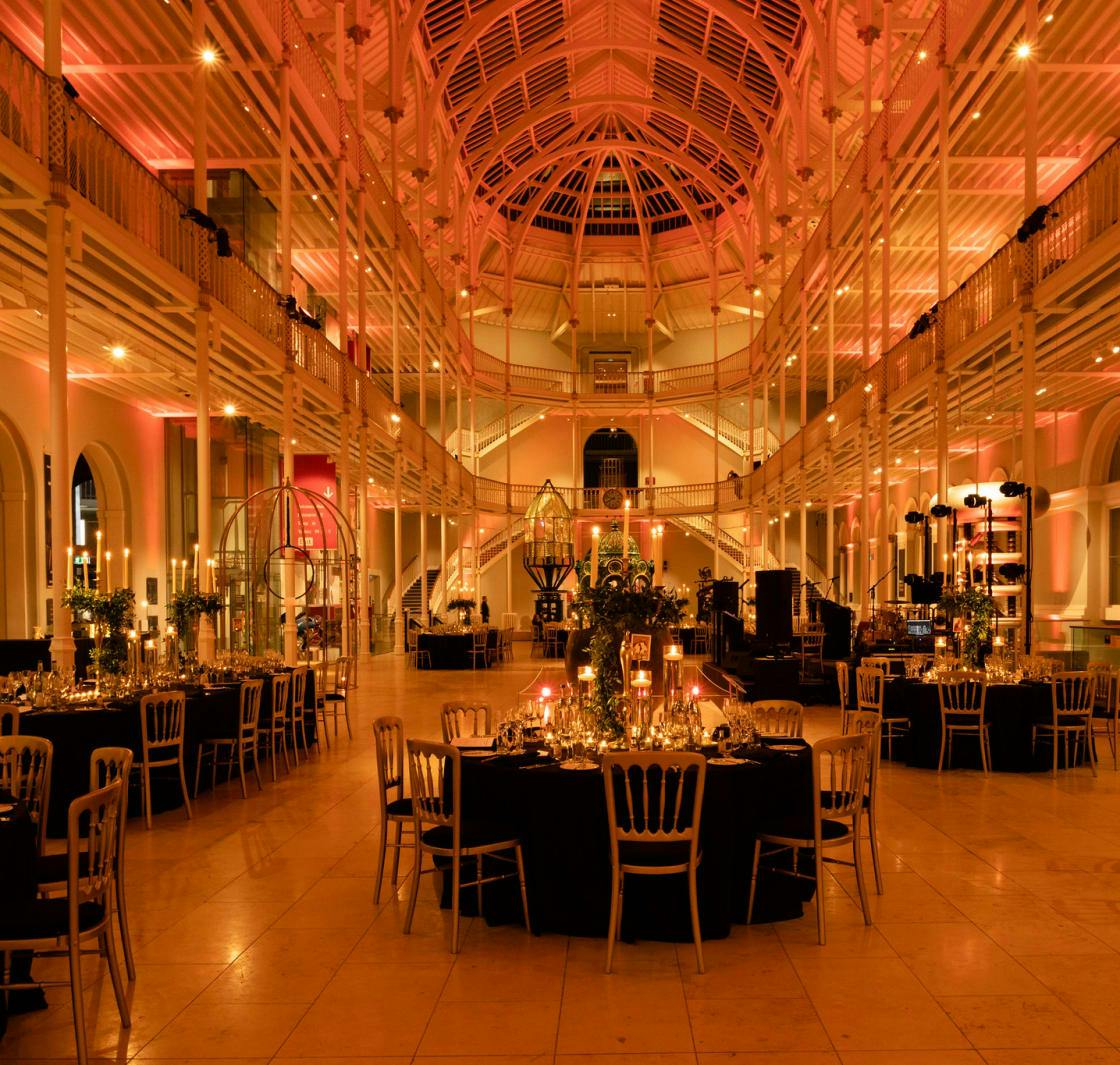 Elegant event space with round tables in National Museum of Scotland for corporate gatherings.