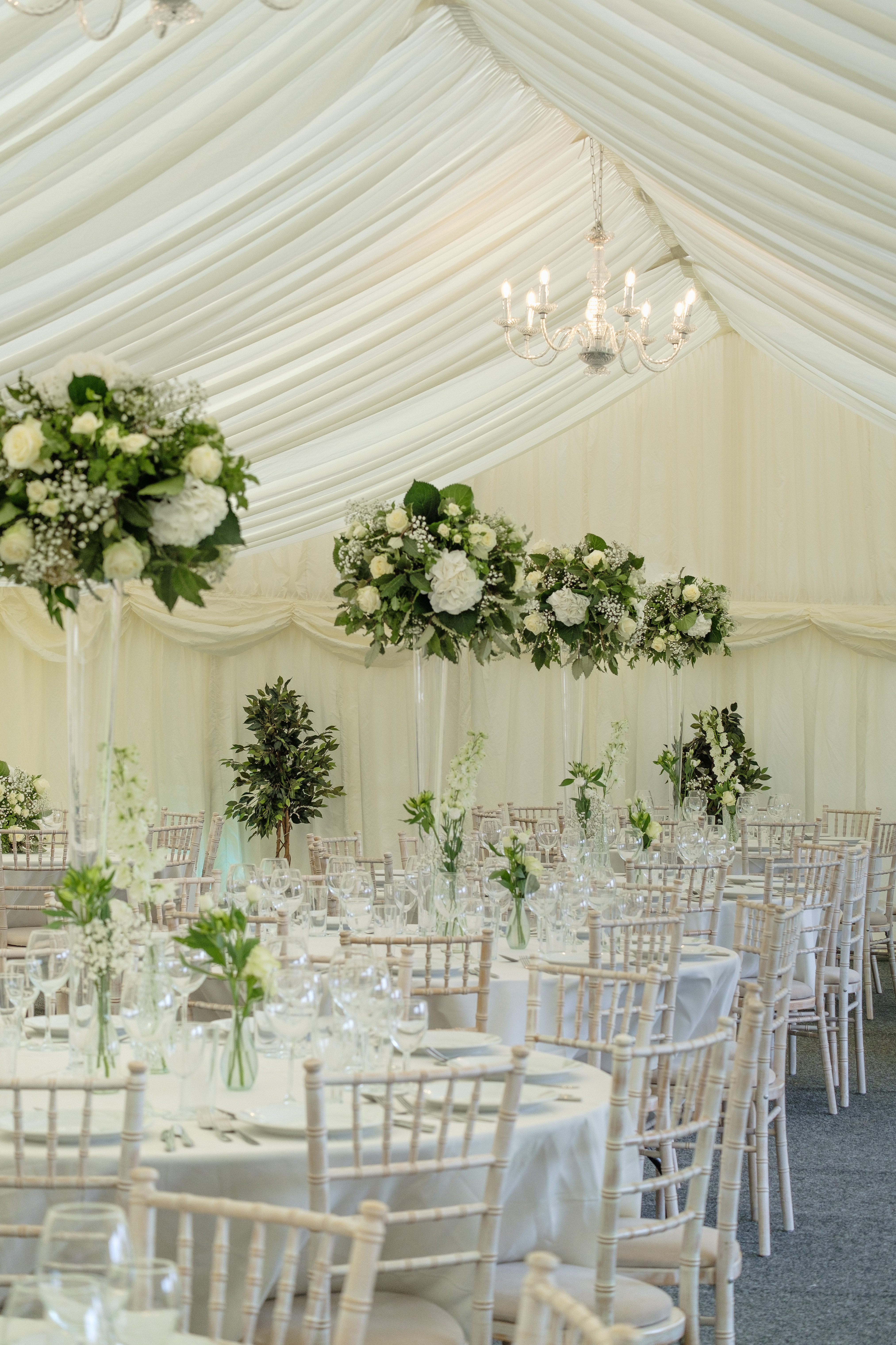 Elegant event space at Parson Lawns with tall floral arrangements for weddings. - Banner