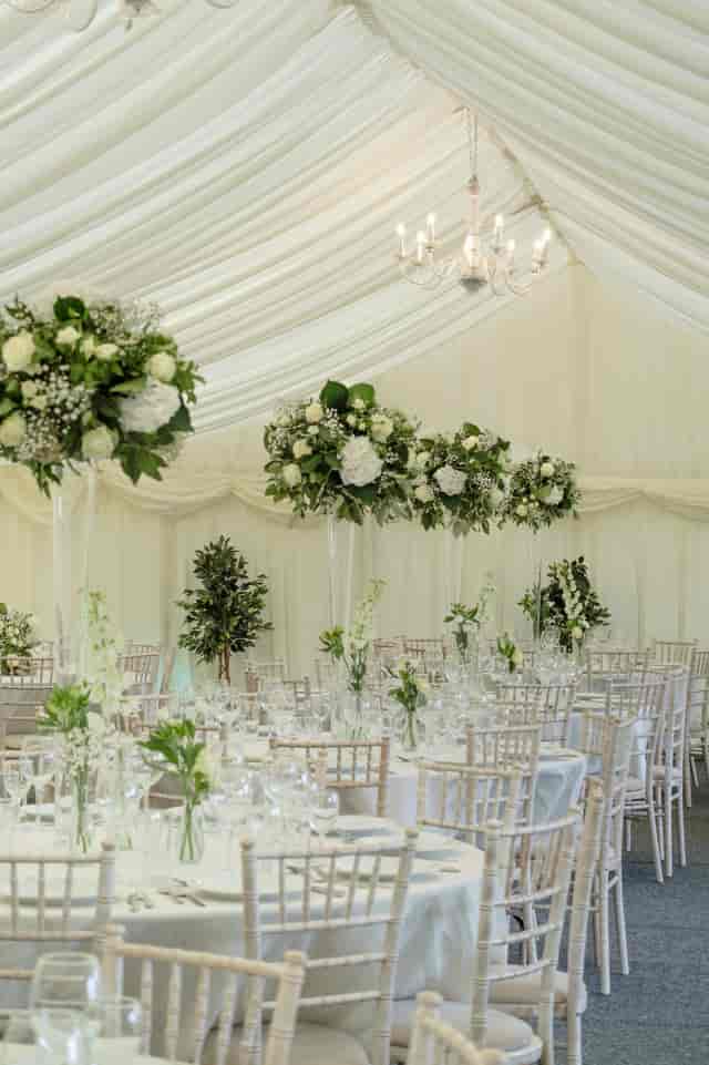 Elegant event space at Parson Lawns with tall floral arrangements for weddings.