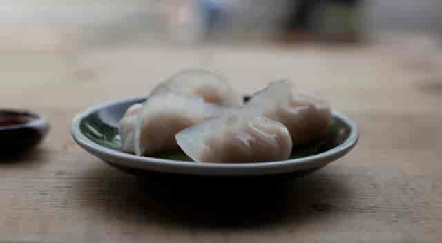 Elegant dumpling plate in Hanging Garden Room for networking culinary event.